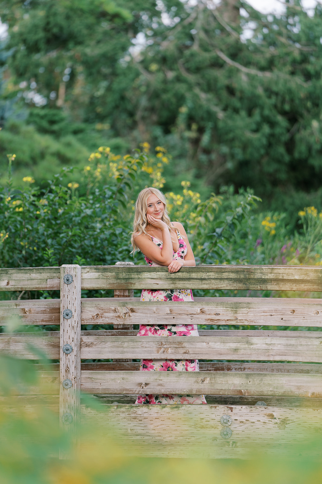 senior pictures on a bridge with flowers